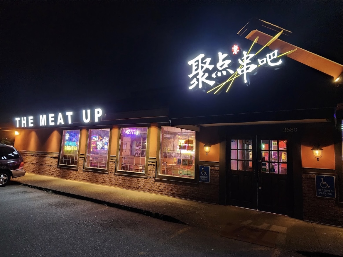 A photo of the exterior of The Meat Up restaurant in Richmond, including its name and its registered trademark